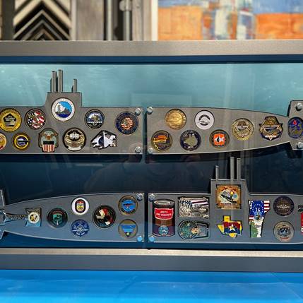 Submarine-shaped challenge coin shadowbox with Plexiglass overlay, underwater background, and hammered gray Soho shadowbox frame.