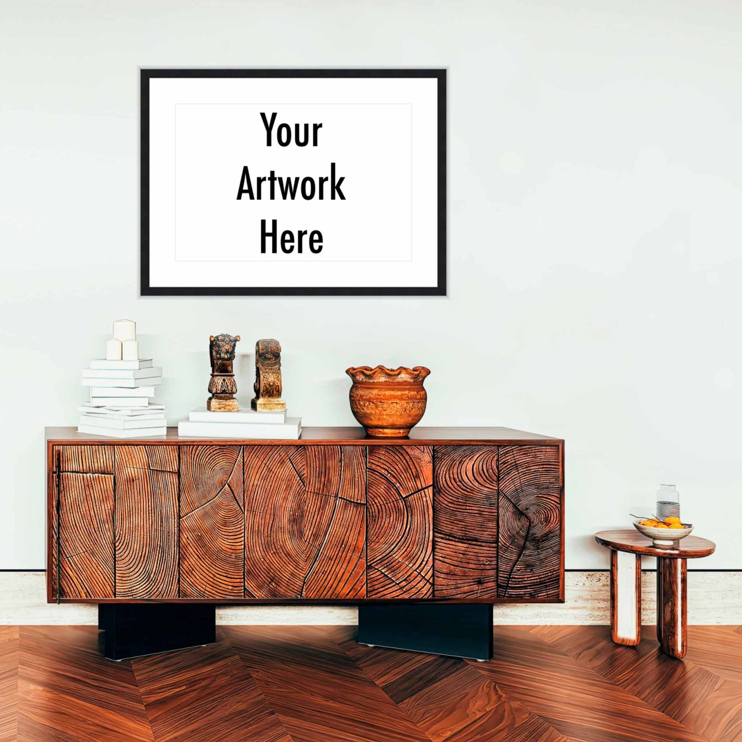 Wooden sideboard with decorative items against a white wall with a customizable artwork frame.