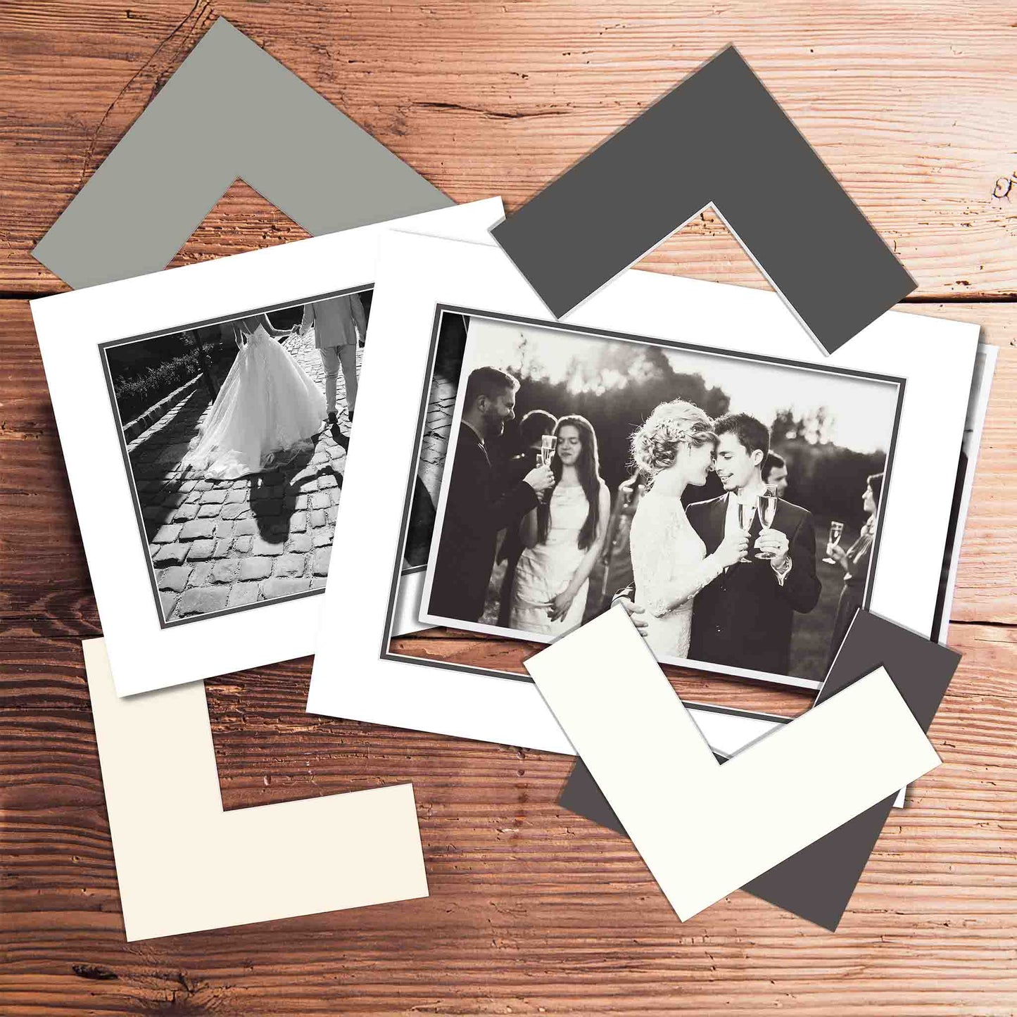 Set of photo frames and black and white photos on a wooden surface with matboard samples