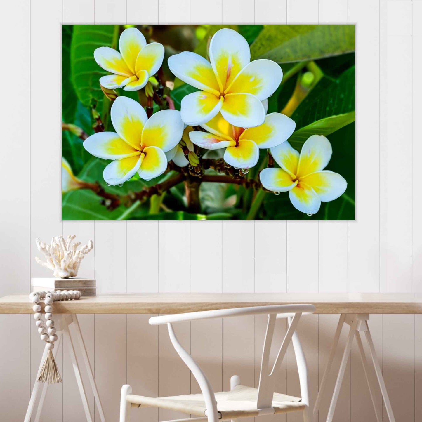 Floral painting on a wall above a wooden table with a chair.