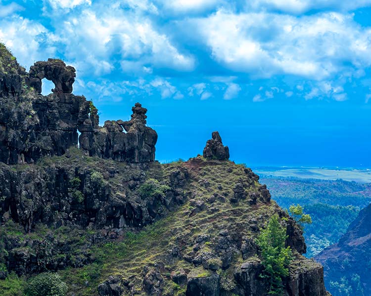 Rugged mountain landscape with rocky outcrops under a blue sky