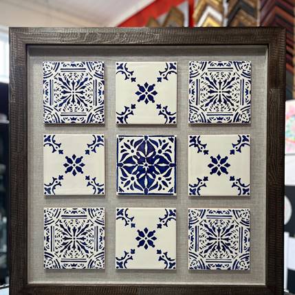 Hand-painted blue and white tiles framed in rustic wood with linen backing, each tile floated for depth and shadow.