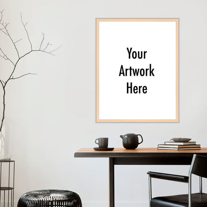 Framed artwork with 'Your Artwork Here' text on a wall above a wooden table.